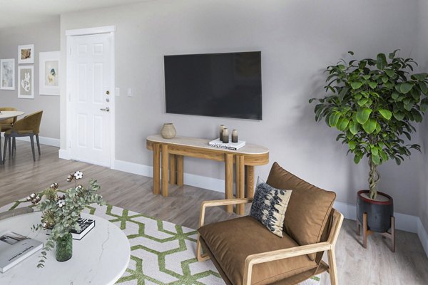 Cozy living room with modern decor and natural light in Arbor Heights Apartments