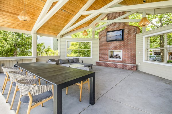 Grill area with modern patio furniture at Arbor Heights Apartments, perfect for outdoor gatherings and relaxation