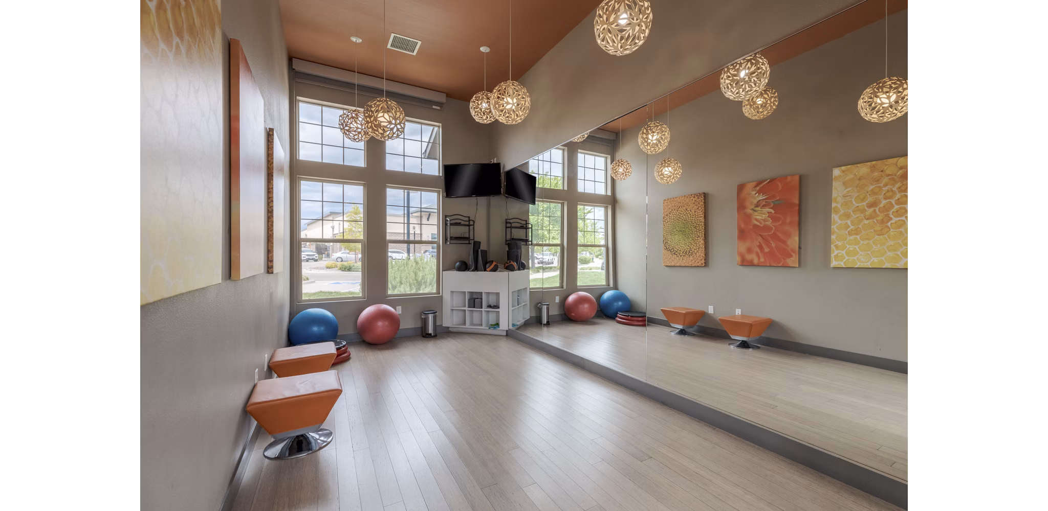 Modern yoga and spin studio with floor-to-ceiling mirrors at Outlook Littleton Apartments, ideal for fitness enthusiasts