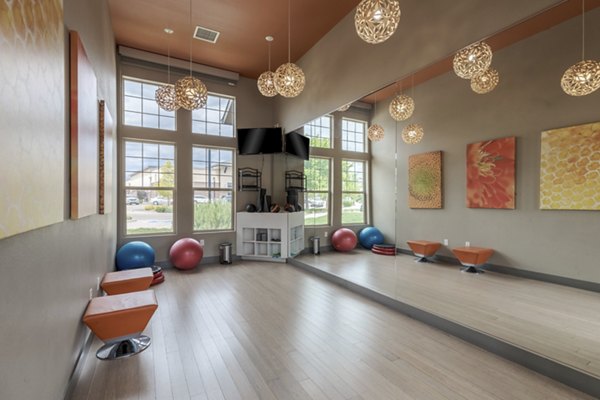 Modern yoga and spin studio with floor-to-ceiling mirrors at Outlook Littleton Apartments, ideal for fitness enthusiasts