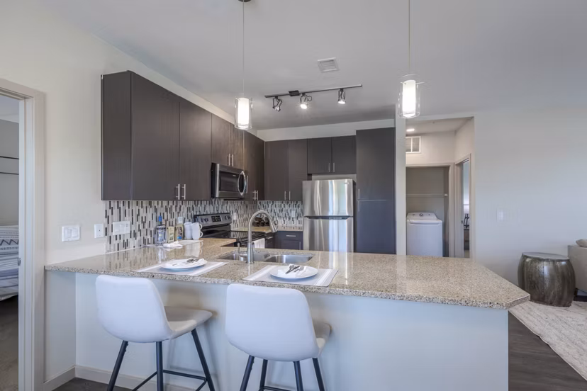 Modern kitchen with stainless steel appliances in Outlook Littleton Apartments