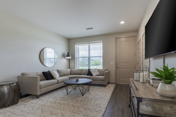 Spacious living room with modern furnishings at Outlook Littleton Apartments