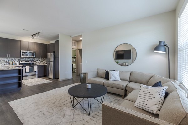 Living room with modern furniture and natural light at Outlook Littleton Apartments