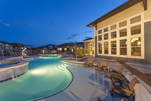 Resort-style pool at Outlook Littleton Apartments surrounded by lush landscaping, perfect for relaxation and leisure