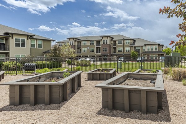 Courtyard at Outlook Littleton Apartments featuring lush greenery and outdoor seating areas