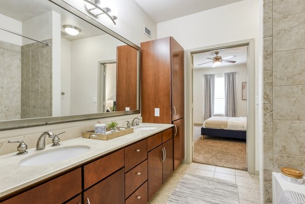 Modern bathroom with sleek fixtures and ample storage at Artessa at Quarry Village Apartments