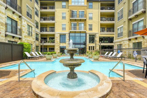 Relaxing poolside with lush landscaping at Artessa at Quarry Village Apartments