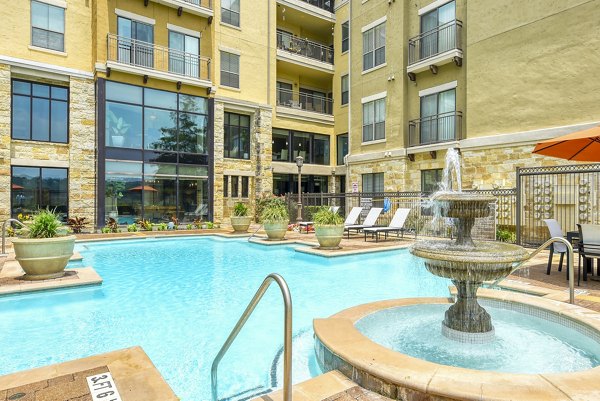 Resort-style pool with sundeck at Artessa at Quarry Village Apartments, luxury living spaces offering relaxation and recreation
