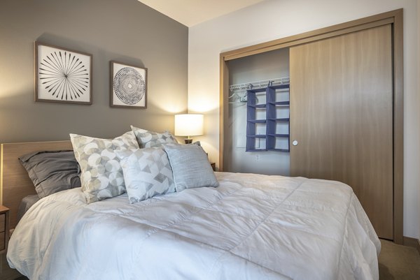 Modern bedroom with elegant design at The Luke Apartments featuring stylish decor and ample natural light