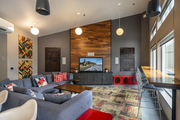 Clubhouse at The Luke Apartments: Modern space with comfortable seating and game area for residents' enjoyment