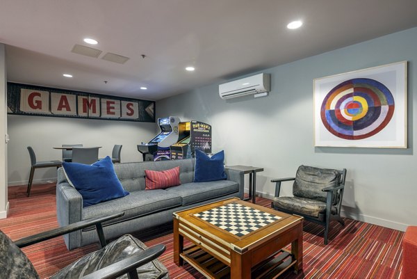 Modern game room featuring billiards and arcade games at The Luke Apartments in a luxury setting