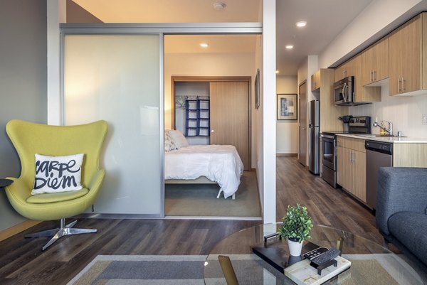 Modern kitchen featuring stainless steel appliances and granite countertops at The Luke Apartments