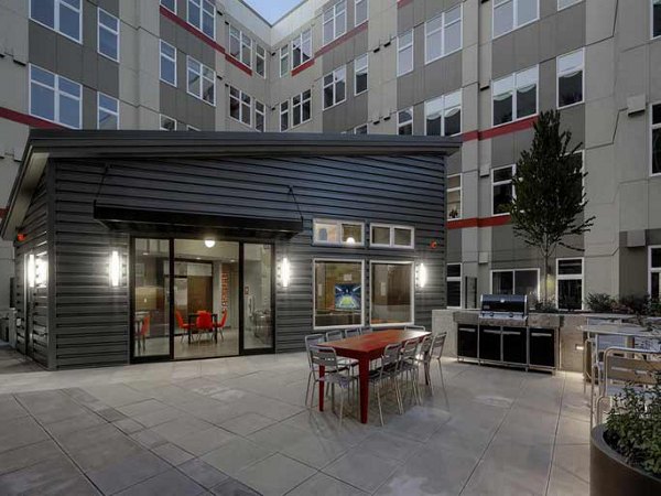 Tranquil courtyard with lush greenery at The Luke Apartments, offering serene outdoor space for residents