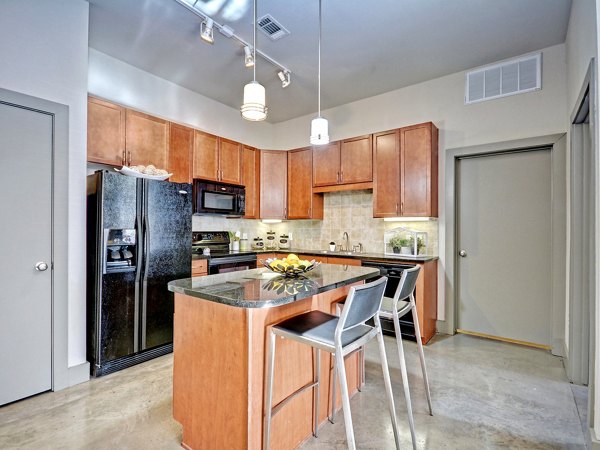 Spacious kitchen featuring modern appliances in The Residence Apartments and Lofts at The Triangle