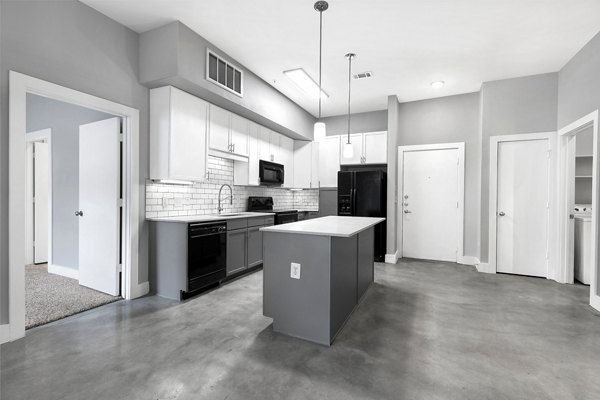 Modern kitchen with stainless steel appliances at Residences at the Triangle Apartments