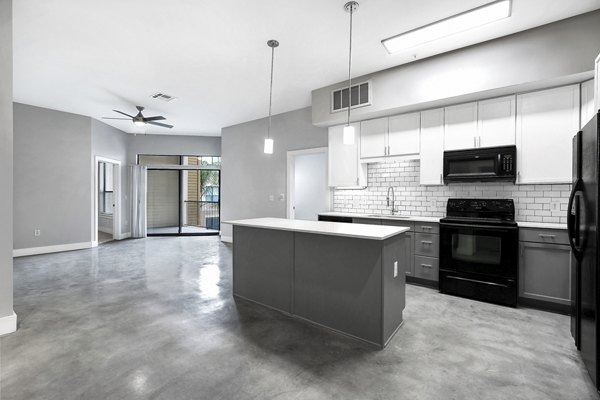 Modern kitchen with stainless steel appliances at Residences at the Triangle Apartments, a Greystar luxury property