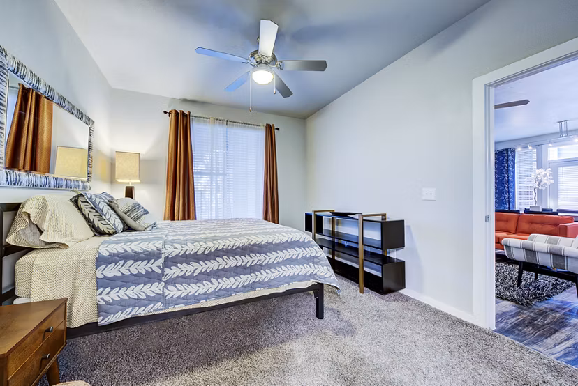 Comfortable bedroom with modern furnishings at Boardwalk Research Luxury Apartments