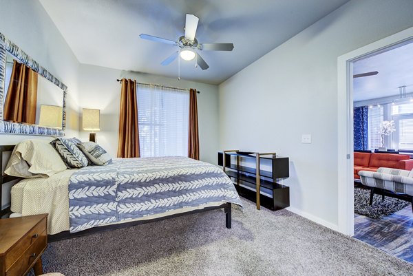 Comfortable bedroom with modern furnishings at Boardwalk Research Luxury Apartments