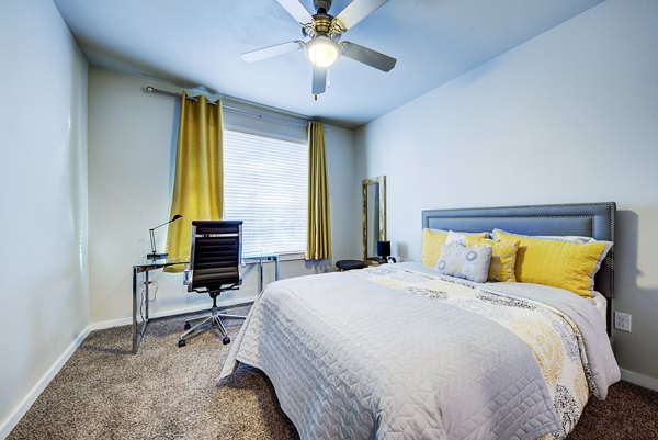 Bedroom with modern decor and ample natural light at Boardwalk Research Luxury Apartments, ideal for comfort and relaxation