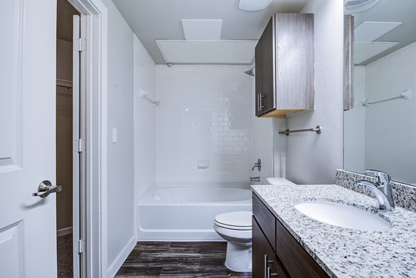 Modern bathroom featuring sleek fixtures and large mirror in Boardwalk Research Luxury Apartments