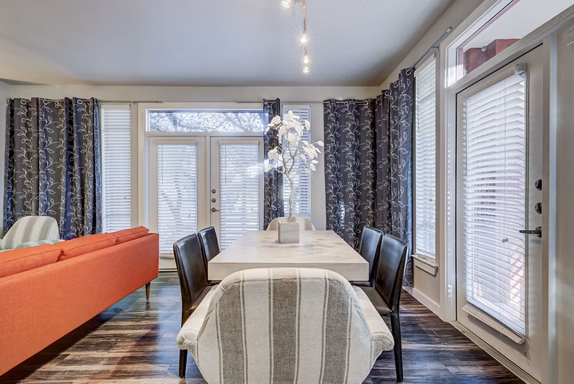 Dining room with elegant furniture and modern lighting in Boardwalk Research Luxury Apartments
