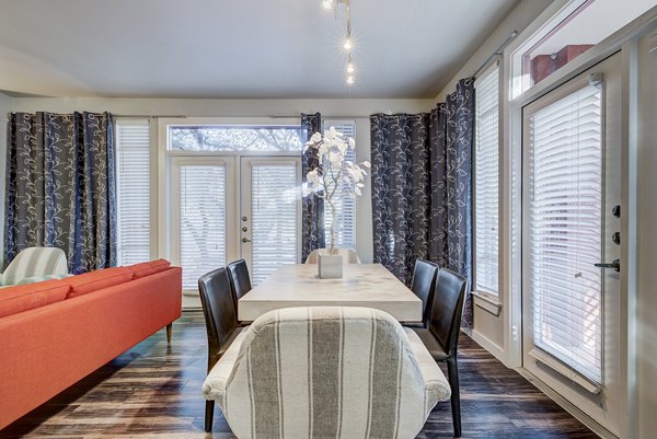 Dining room with elegant furniture and modern lighting in Boardwalk Research Luxury Apartments