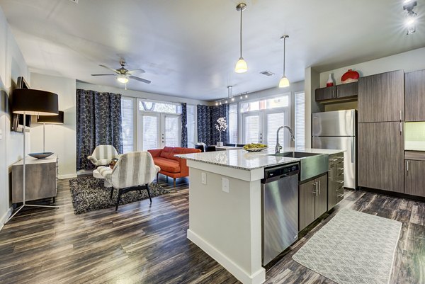 Modern kitchen with stainless steel appliances at Boardwalk Research Luxury Apartments