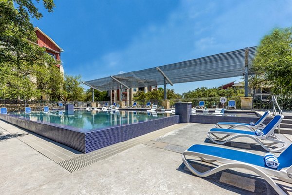Rooftop pool with city skyline views at Boardwalk Research Luxury Apartments