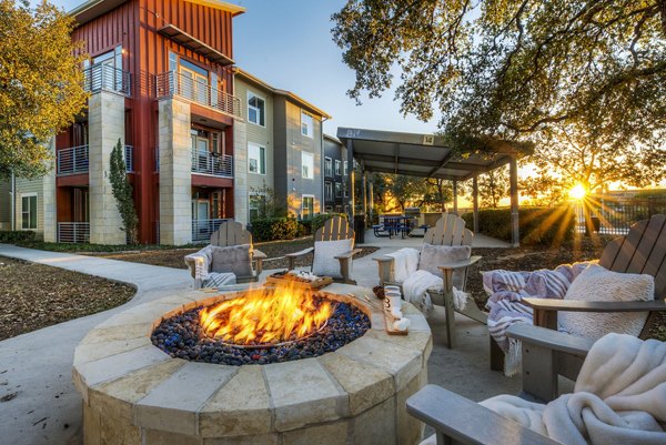 Cozy fire pit area at Boardwalk Research Luxury Apartments, ideal for outdoor relaxation and socializing