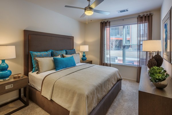 Bedroom with modern decor and ample natural light at 1100 South Apartments
