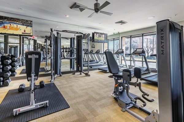 Modern fitness center with advanced equipment at 1100 South Apartments, offering residents a luxury workout experience