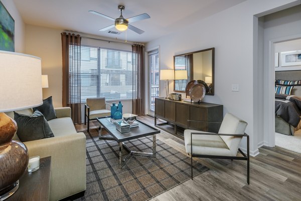 Spacious living room with modern furniture and natural light in 1100 South Apartments, Greystar luxury apartment living