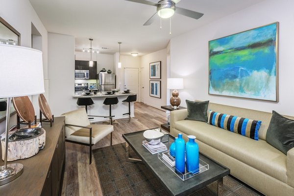 Modern living room with sleek furnishings and large windows at 1100 South Apartments, offering luxury living in the heart of the city