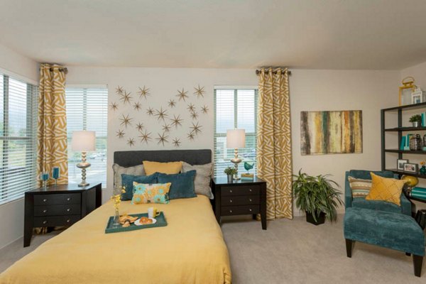 Cozy bedroom with modern furnishings at Outlook Golden Ridge Apartments, offering luxury living spaces