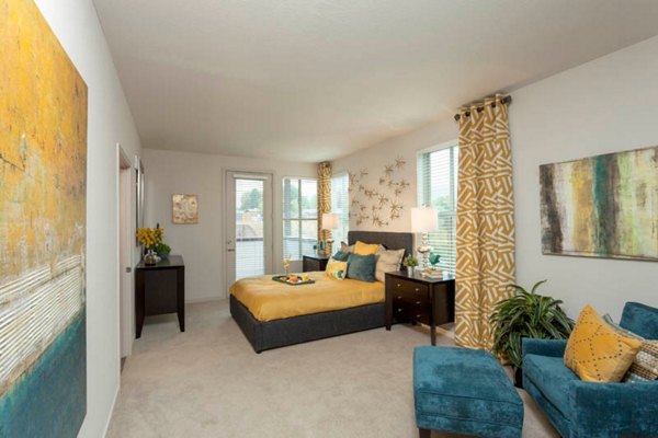 Cozy bedroom with modern furniture at Outlook Golden Ridge Apartments, offering luxury living spaces