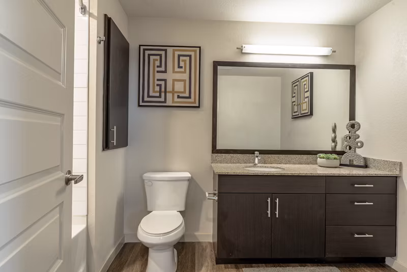 Modern bathroom with sleek fixtures and granite countertops at Outlook Golden Ridge Apartments, offering luxury living near Denver