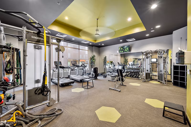 State-of-the-art fitness center with modern equipment at Outlook Golden Ridge Apartments in Golden, featuring a spacious workout area for residents