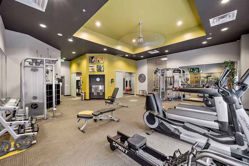 State-of-the-art fitness center equipped with modern exercise machines at Outlook Golden Ridge Apartments