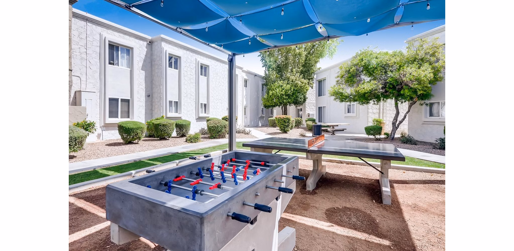 Outdoor sport court with basketball hoops at The Cortesian Apartments