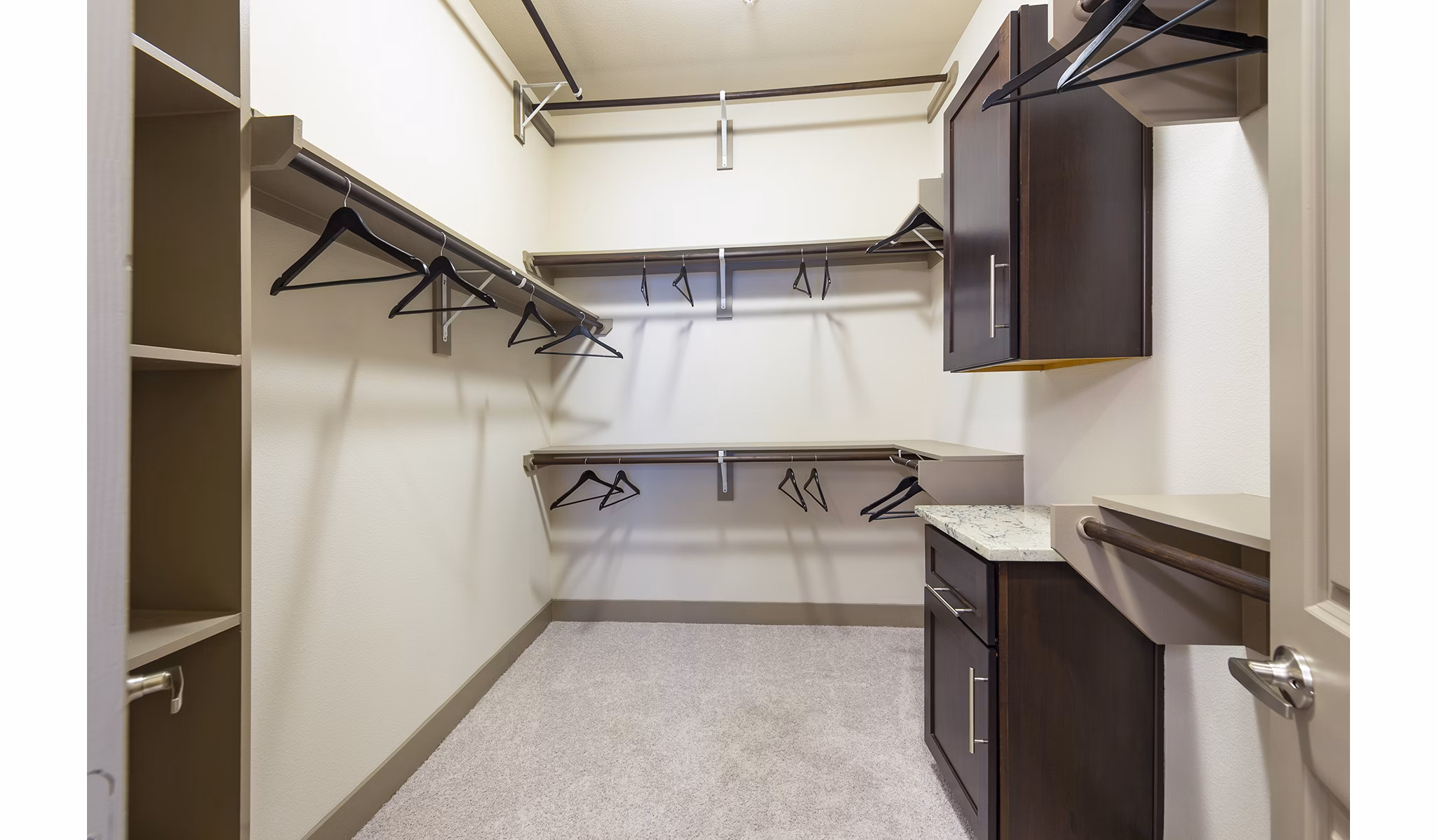 Walk-in closet with ample shelving in the bedroom at Virage Luxury Apartments