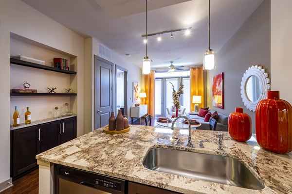 Spacious kitchen featuring sleek countertops and modern appliances in Virage Luxury Apartments