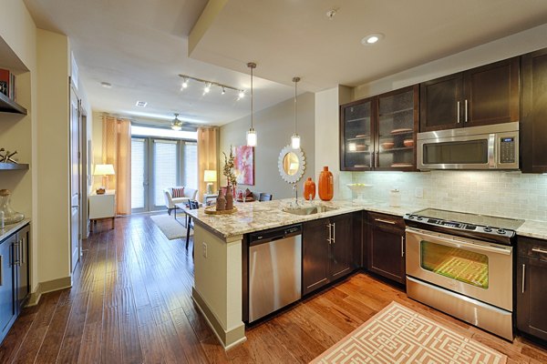 Modern kitchen with stainless steel appliances at Virage Luxury Apartments