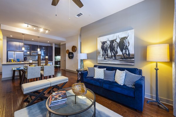 Contemporary living room with stylish decor and city views at Virage Luxury Apartments