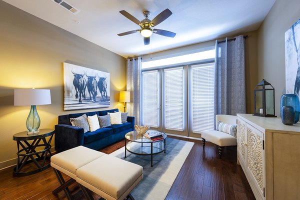 Elegant living room with cozy seating and modern decor at Virage Luxury Apartments
