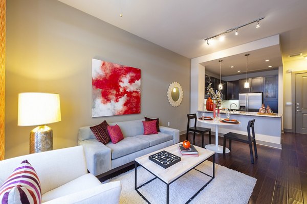Stylish living room with modern decor in Virage Luxury Apartments, featuring comfortable seating and large windows