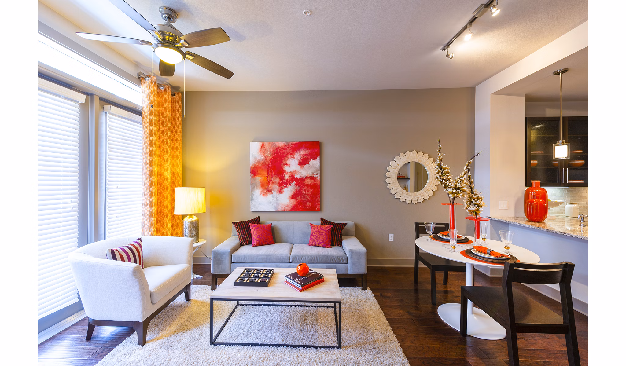 Spacious living room with modern furniture and large windows in Virage Luxury Apartments
