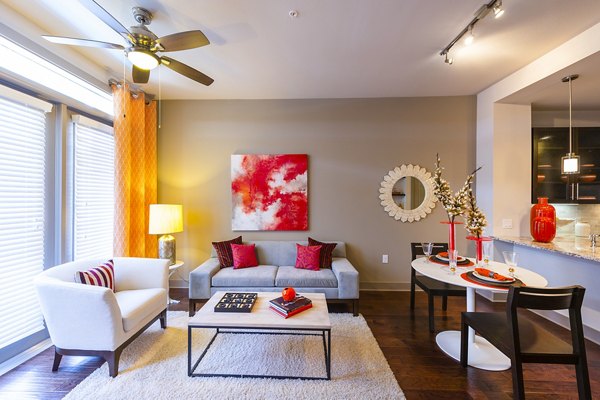 Spacious living room with modern furniture and large windows in Virage Luxury Apartments