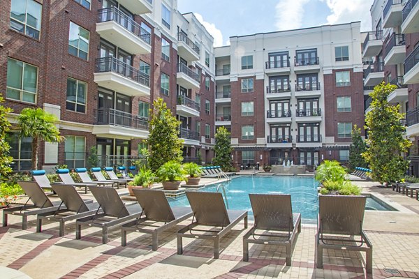 Inviting pool at Virage Luxury Apartments with lounge seating and palm trees