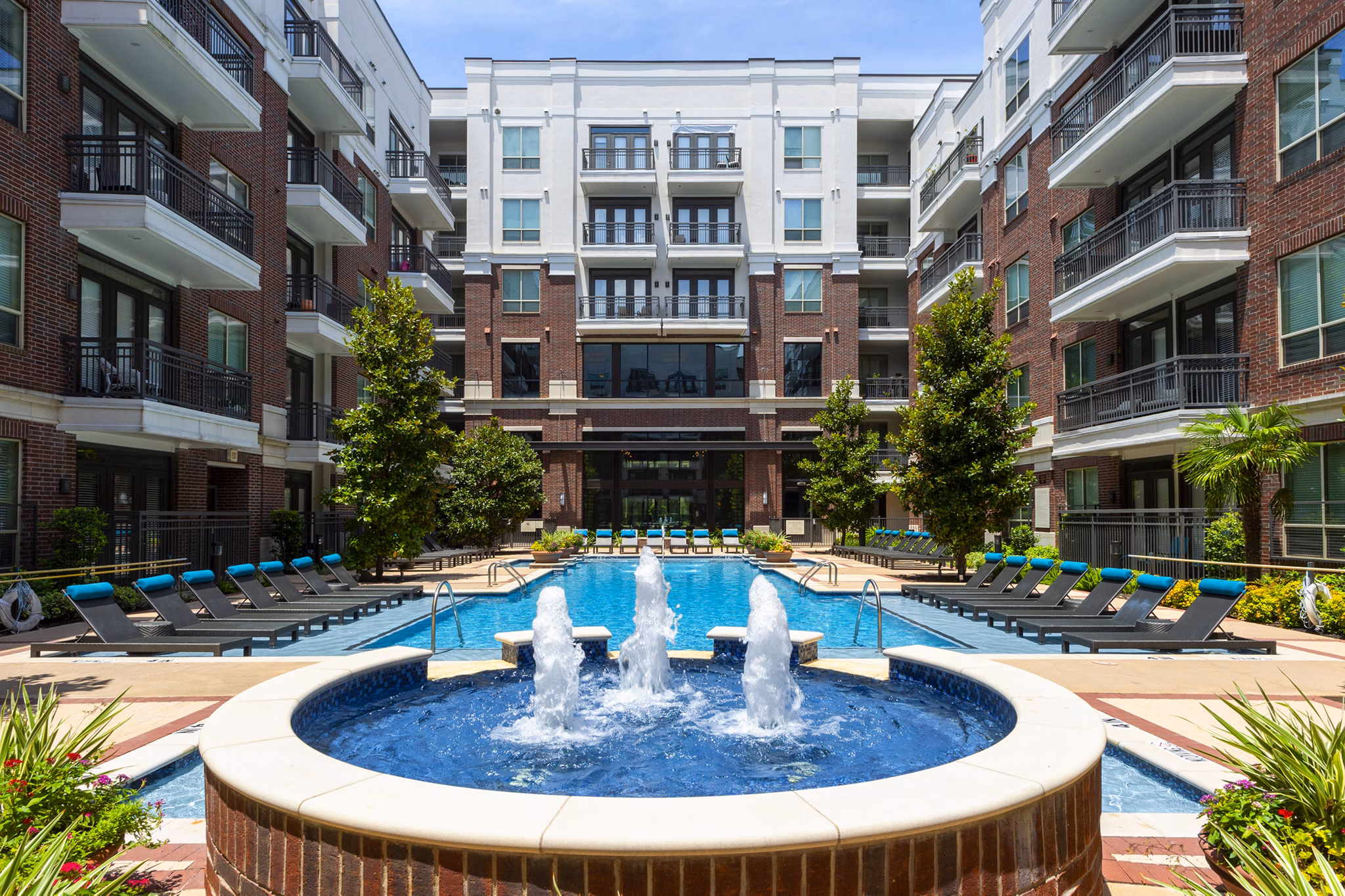 Outdoor pool with resort-style seating at Virage Luxury Apartments