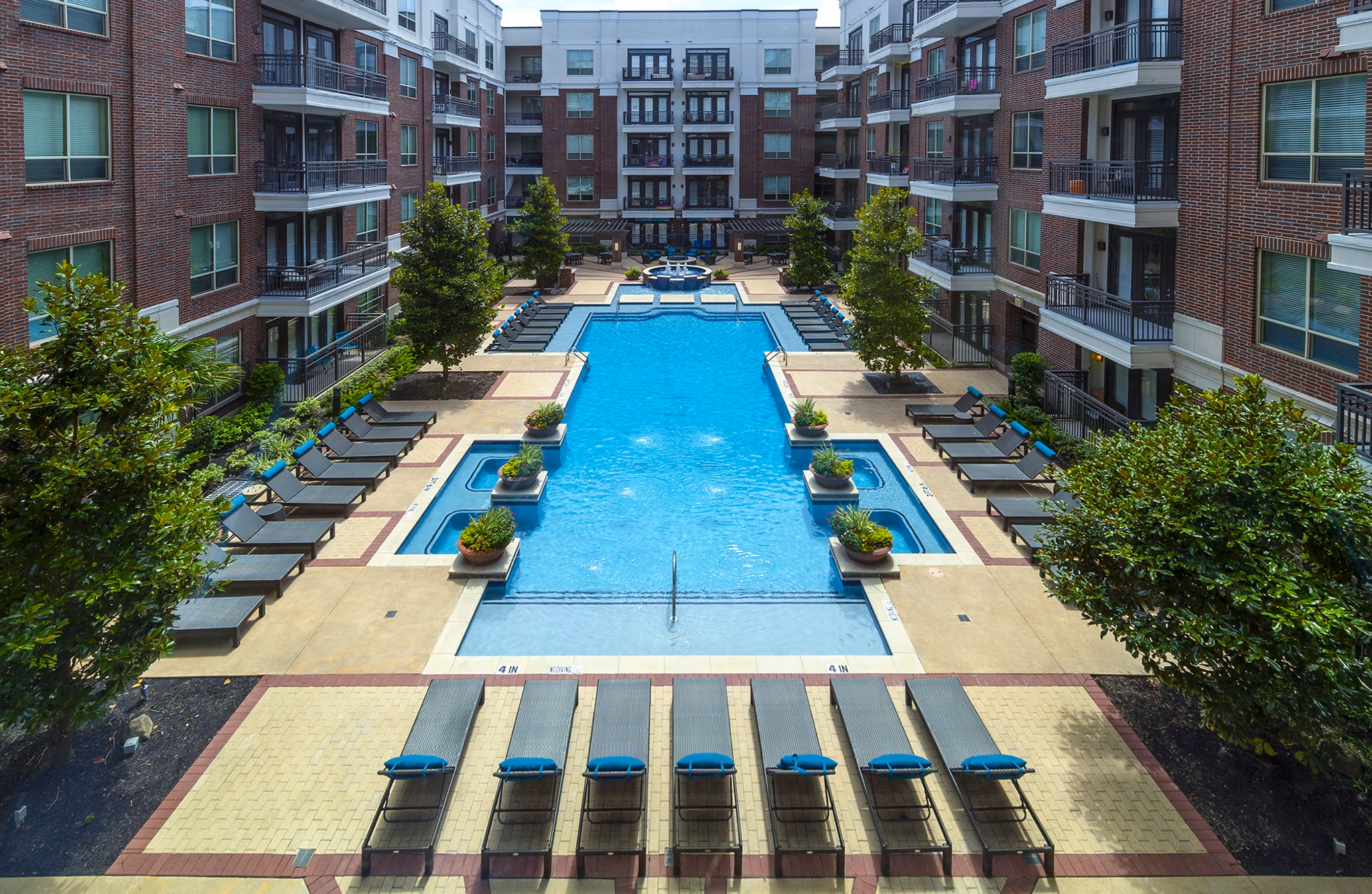 Luxurious outdoor pool area with lounge seating at Virage Luxury Apartments, perfect for relaxation and social gatherings